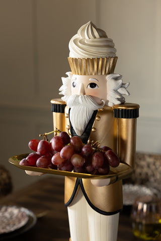 The Gold Nutcracker Butler Christmas Decoration with some grapes styled on the tray.