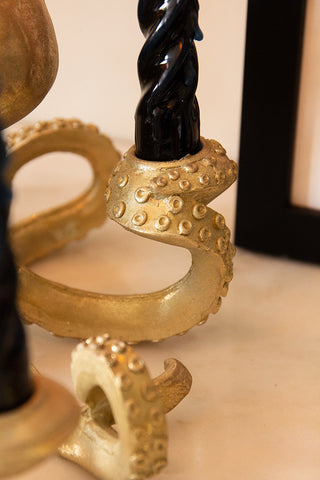 Close-up of the Gold Octopus Candlestick Holder with a candle inside.