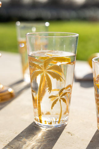 Lifestyle image of the Gold Palm Water Glass