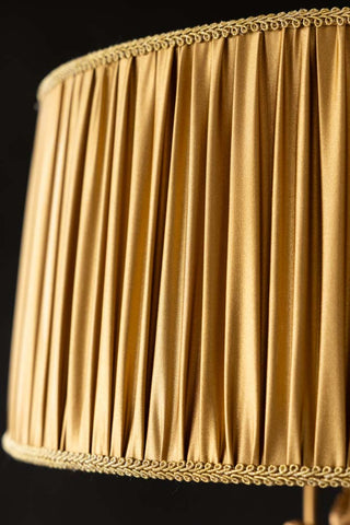 A close up detail of the Gold Ruched Hanging Bird Pendant Light shade, showing the ruched detail and gold trim. 