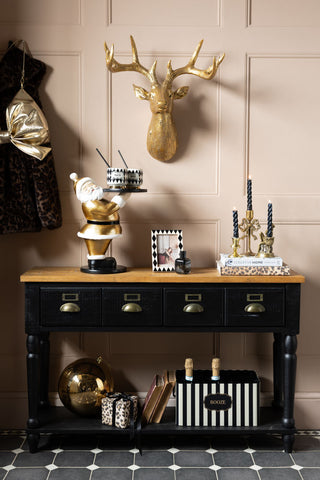 The Gold Santa Butler Christmas Decoration styled as part of a festive sideboard look.