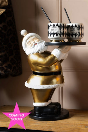 The Gold Santa Butler Christmas Decoration styled with two cocktail cups on. Shown with a pink star icon that reads 'coming soon'.
