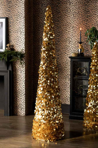 The Gold Tinsel Christmas Tree Cone - Large shown in a leopard print living room. 