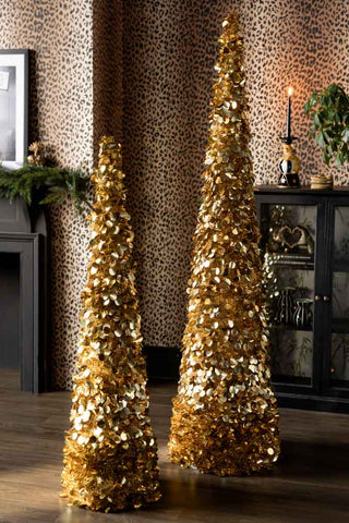 The Gold Tinsel Christmas Tree Cone - Large and the medium version shown in a leopard print living room. 