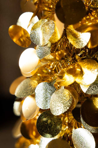 The texture of the gold sequin discs on the Gold Tinsel Christmas Tree Cone - Medium. 