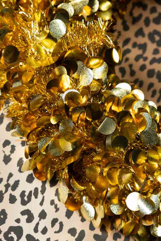 Close up of the gold foil disc sequins and tinsel on the Gold Tinsel Sparkle Christmas Wreath. 