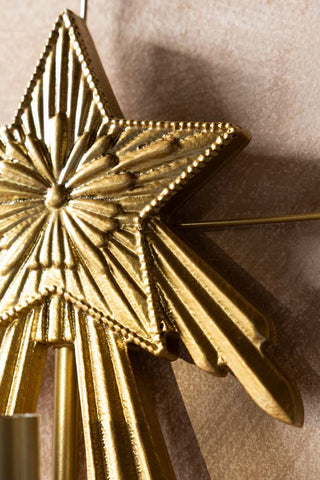 Close-up detail of the star on the Gold Star Candle Wall Sconce. 