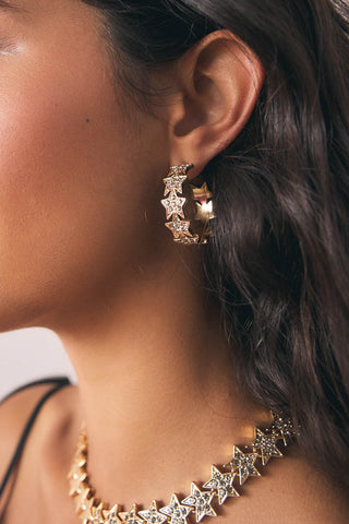 Close-up image of the Gold Star Hoop Earrings