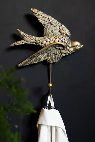 Lifestyle image of the Gold Swallow Coat Hook