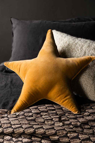 Lifestyle image of the Gold Star Velvet Cushion