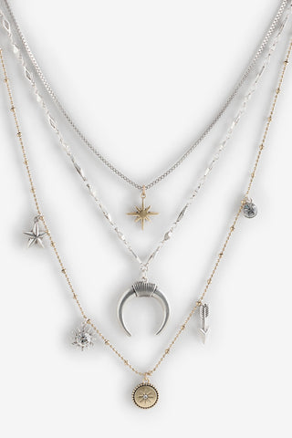 Close-up of the Gold & Silver Charm Layered Necklace on a white background.