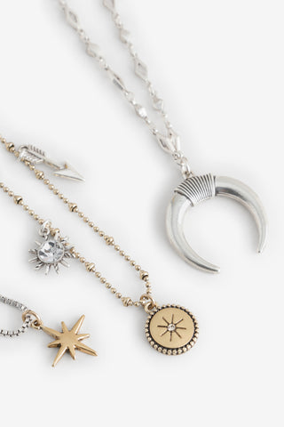 Close-up of the charms on the Gold & Silver Charm Layered Necklace.