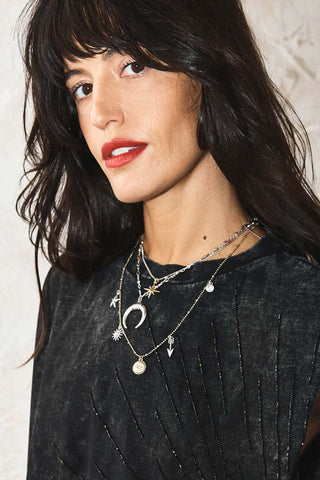 The Gold & Silver Charm Layered Necklace worn by a model.