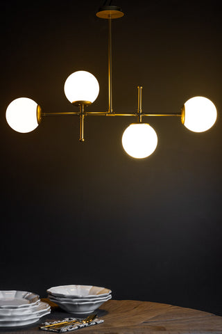 Lifestyle image of the Gold & White Glass Globe Ceiling Light.