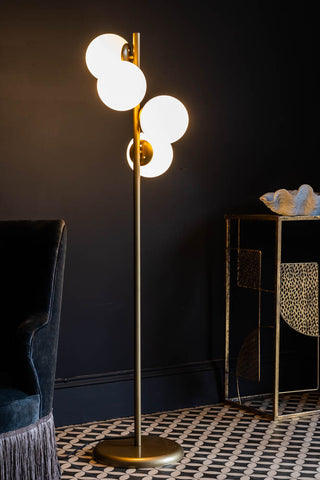 Lifestyle image of the Gold & White Opaque Globe Floor Lamp.
