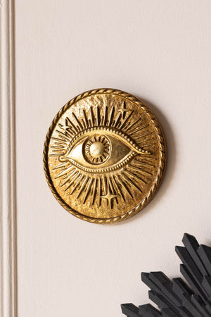 The Golden Mystic Eye Wall Hanging Decoration on the wall.
