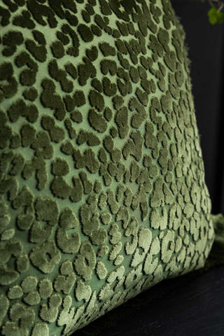 Close-up of the design on the Green Leopard Velvet Cushion with Fringe Trim.