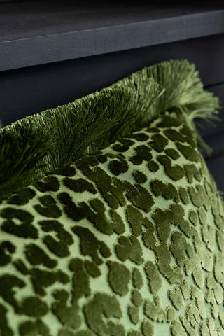 Close-up of the fringing on the Green Leopard Velvet Cushion with Fringe Trim.