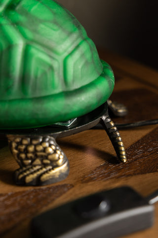 Detail of the tail on the Green Speckled Glass Turtle Table Lamp. 