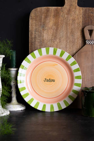 The Green & Pink J’adore Ceramic Serving Plate leaning on a black kitchen backdrop.