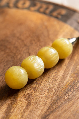 The yellow bobbin handle on the The HKLIVING Cheese Knives. 