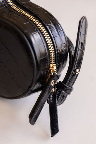 Close-up of the zip on a black heart shaped bag.