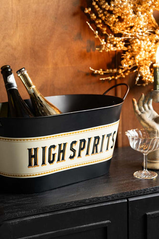 The High Spirits Wine Cooler styled on a sdieboard with various accessories.
