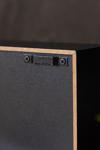 Close-up of the fixing on the reverse side of the Home Is Where The Fuckers Aint Light Box.