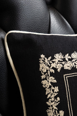 Close-up of the corner of the Home Sweet Fucking Home Embroidered Cushion.