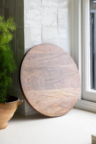 The back of the Home Sweet Fucking Home Wooden Serving Board shown against white zellige tiles. 