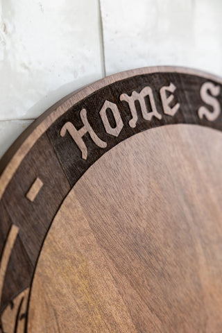 The text border of the Home Sweet Fucking Home Wooden Serving Board. 