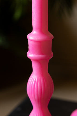 A close up showing the detailing on the Hot Pink Candlestick Shaped Candle - Tall. 