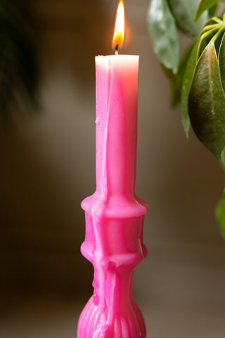 Close up of the top of the Hot Pink Candlestick Shaped Candle - Tall, showing the candle lit and wav running down the side. 