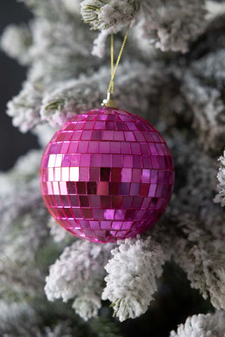 The Hot Pink Disco Ball Christmas Decoration on a Christmas Tree