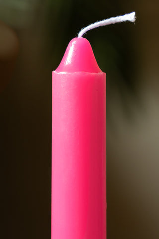 Detail of the Hot Pink Short Dinner Candle, with the wick unlit. 