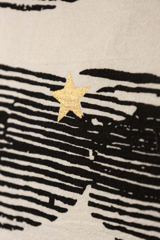 Detail shot of the motifs on the Hot Pink & Gold Star Print Reversible Cushion.