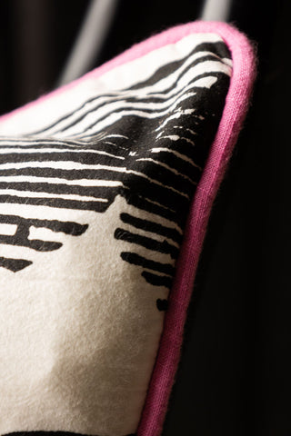 Detail shot of the corner of the Hot Pink & Gold Star Print Reversible Cushion.