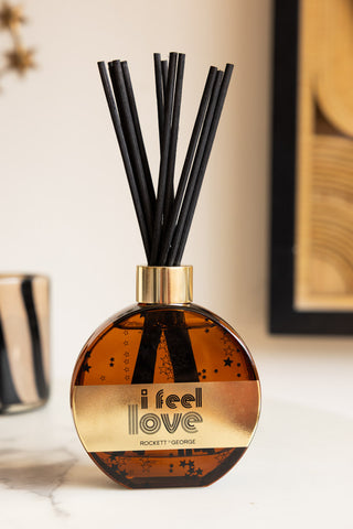 The I Feel Love Cedarwood & Frankincense Reed Diffuser displayed on a white surface.