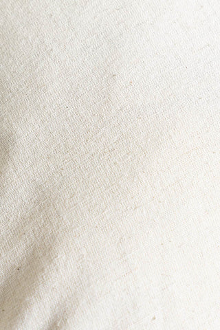 Close-up of the fabric of the In This House We Swear Embroidered Cushion.