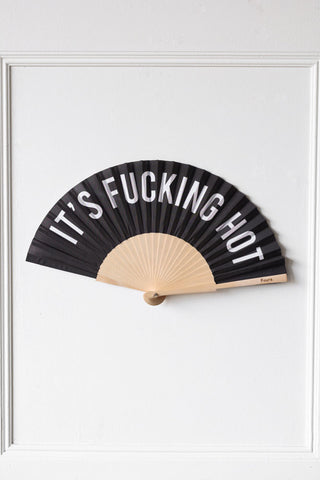 Image of the It's Fucking Hot Wooden Fan on a wall