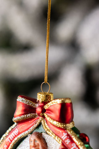 Detail shot of the bow on top of a hanging christmas tree decoration.
