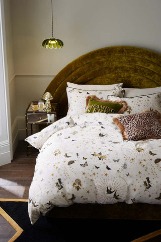 The Jane's Rose Duvet Cover and Pillow Case Set styled on a bed with cushions. There is also a bedside table, rug, light and various home accessories.