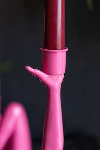 Close-up of the top of the Kicking Leg Candle Holder In Hot Pink with a candle inside.