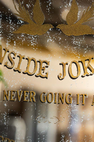 Detail showing the gold vintage style text on the Kindred Spirits Decorative Mirror.
