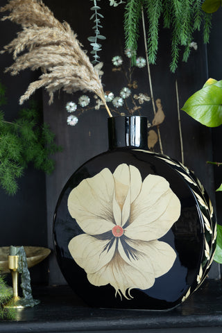 Portrait image of the black and floral vase.
