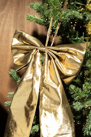 The Large Gold Bow Christmas Decoration styled on a Christmas tree.