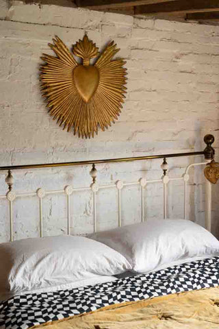 Image of the Large Golden Milagro Heart Wall Art above a bed