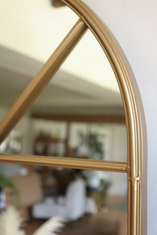 Detail of tall gold arched mirror