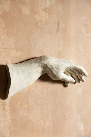 The Large White Helping Hand Wall Art shown on a plaster wall. 