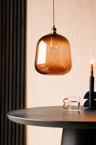 Lifestyle image of the Large Burnt Butterscotch Glass Ceiling Light against wooden panelling  